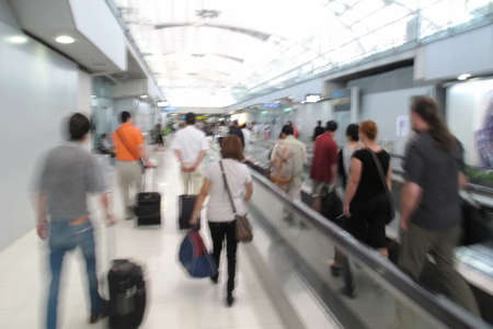 blurred passenger walking in airport terminal backgroundのeditorial素材