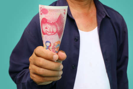businessman holding yuan RMB in his handsの写真素材