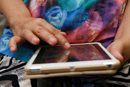 eldery women use tablet at home