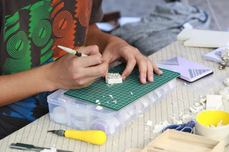 man hand use knife crafting rubber stampのeditorial素材