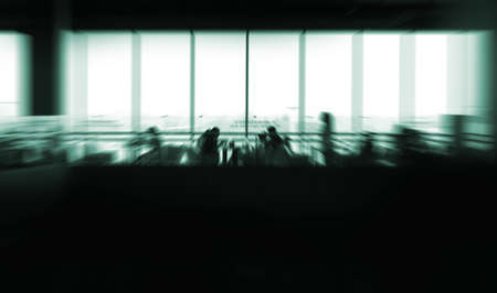 blurred people in office with glass wall backgroundの写真素材