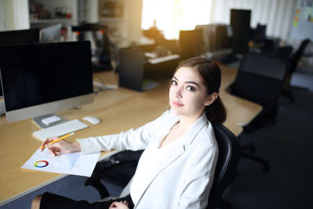 Smart young businesswoman crew working with new startup project in modern loft office. Generic design notebook education and inspiration lifestyle. Europe and European people.の写真素材