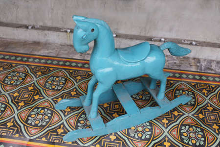 blue purple rocking wood horse ,Vintage old rocking horse on a wooden, toy child groundの写真素材
