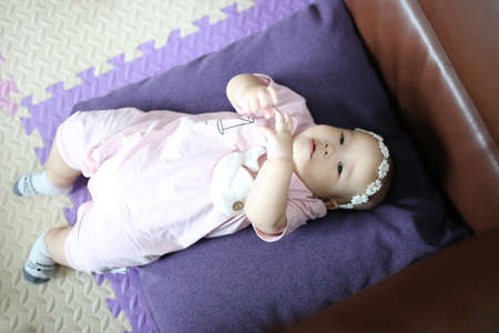 mother reach hand lift up play and show throws cute happy baby on sky in house living room at morning time after awake concept. enjoy parenting emotion and good feeling family. smart generationの写真素材