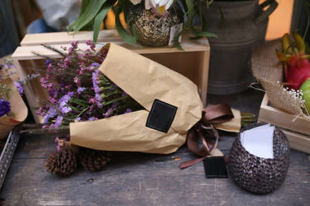 entrance into flower shop block wall building and steel door in market , romantic pink lily flower in metal vase pot with plastic paper cover background , export colorful floral businessの写真素材