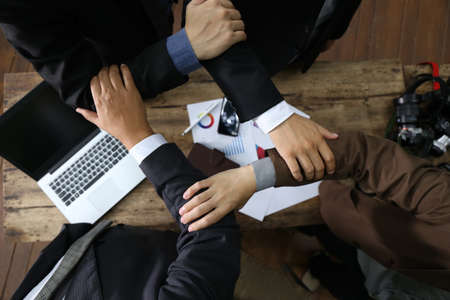 banker businessman people group working with laptop and financial document chart on wood table together.の写真素材