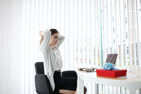 Smart Businesswoman handshake for closing the deal with business people team happy good success result in office concept background. Gift new year red box to staff.の写真素材