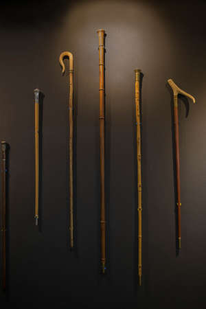 elegant Set of walking sticks and crutches. Telescopic metal canes, wooden cane with additional support, elbow crutch. Medical devices for help accident peopleの写真素材