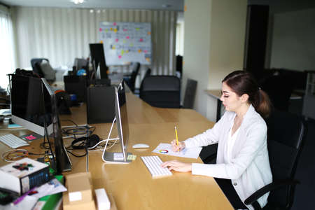 Smart young businesswoman crew working with new startup project in modern loft office. Generic design notebook education and inspiration lifestyle. Europe and European people.の写真素材