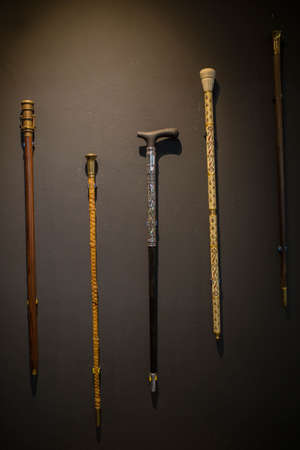 elegant Set of walking sticks and crutches. Telescopic metal canes, wooden cane with additional support, elbow crutch. Medical devices for help accident peopleの写真素材