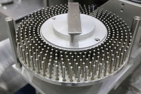 drug capsule and pill press machine in medicine manufacturing factory health and hospital business background.の写真素材