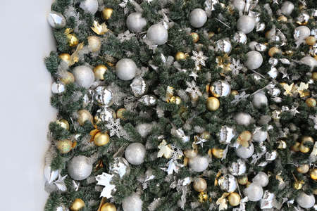gold color Christmas ball hang on green pine tree with blurred night light new year party background.の写真素材