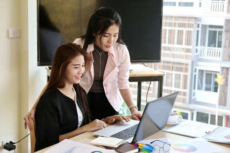 Two Woman Typing Keyboard Laptop Hand. Business Team Working Startup modern Office.Global Strategy Virtual Icon.Innovation Graphs Interfaces. Asian business team negotiating discussing workの写真素材