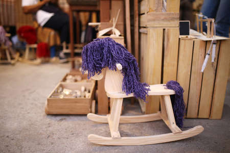 blue purple rocking wood horse ,Vintage old rocking horse on a wooden, toy child groundの写真素材
