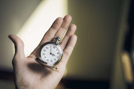 Vintage pocket watch in handの写真素材