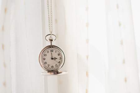 Vintage pocket watch and white drape background