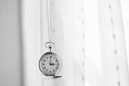 Vintage pocket watch and white drape background