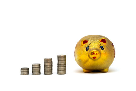 Golden Piggy bank and coins isolated on white background