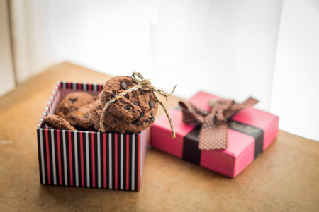 Chocolate cookies and Gift box on wood table