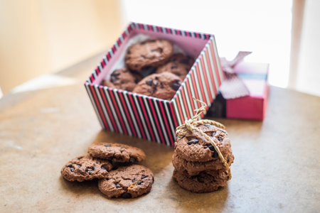 Chocolate cookies and Gift box on wood table