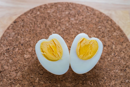Heart shaped boiled eggs on wood table