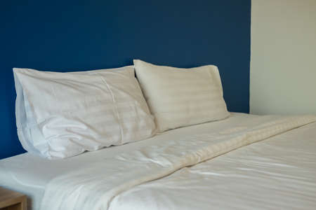Pillows on bed in the hotelの写真素材