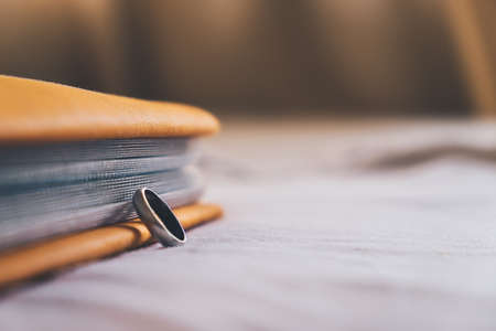 Ring and a book on the bedの写真素材