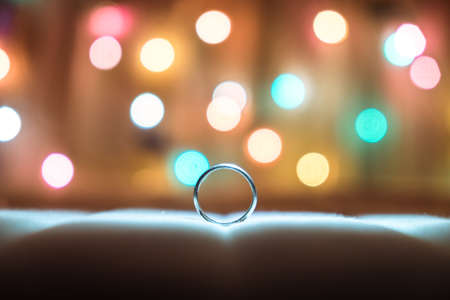 Ring placed on a bed wiith bokeh backgroundの写真素材