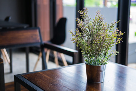 Artificial Plant in a pot on wood table