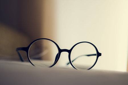 Vintage glasses on a bedの写真素材