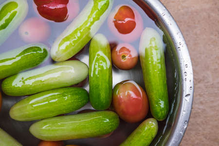 Cucumber and Tomato in water on a bowl Steelの写真素材