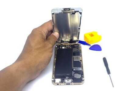Hand man repair smartphone with tools, isolate, smartphone damage need to repairの写真素材
