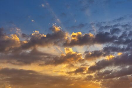 Sky with cloud and sun ray yellow and blue color background. With copy space for text or design.の写真素材