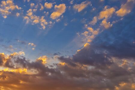 Sky with cloud and sun ray yellow and blue color background. With copy space for text or design.の写真素材