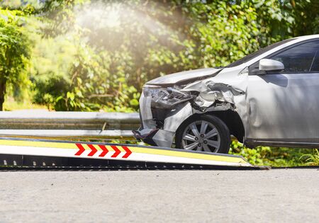 accident Car Slide on  truck for move. White car have damage by accident on road take with slide truck move . の写真素材