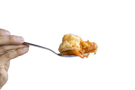 Close up Woman hand hold a spoon  shrimp from Tom Yum Kung  on white background. Save   .の写真素材
