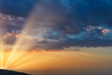 Sky with cloud and sun ray yellow and blue color background. With copy space for text or design.の写真素材