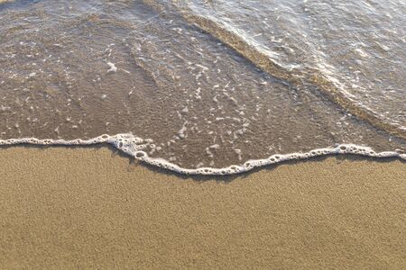 Top view Soft wave from sea come to wet sand beach background. With copy space for text or designの写真素材