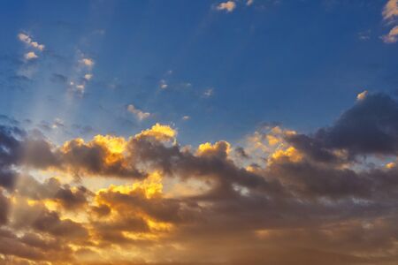 Sky with cloud and sun ray yellow and blue color background. With copy space for text or design.の写真素材