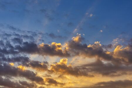 Sky with cloud and sun ray yellow and blue color background. With copy space for text or design.の写真素材