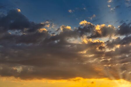 Sky with cloud and sun ray yellow and blue color background. With copy space for text or design.の写真素材