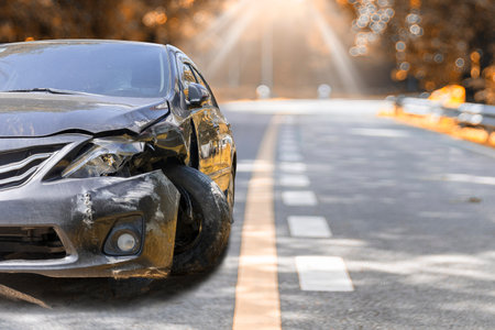 Artumn road. Front of black color car big damaged and broken by accident on road parking can not drive any more. With copy space for text or designの写真素材