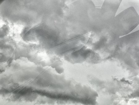 Black cloud before rainy. Black cloud background. Shot from car mirror. Process with more grain. With copy space for text or design.の写真素材