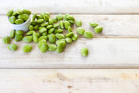 Bitter Beans on wood table. With copy space for text or design.の写真素材
