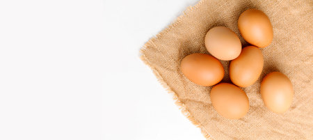 Close up Top view fresh chicken eggs on linen tablecloth with copy space banner. の写真素材