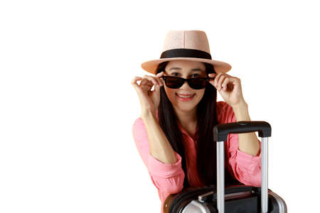 Asian women long hair wear hat, sunglasses, with travel bag and hand holding glasses. Women with suitcase and passport on white background. Summer travel concept.の写真素材