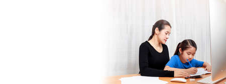 Mother and daughter learning to write, mother teaching little girlの写真素材