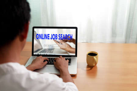 Business and job concept. Man use laptop computer online website find new career. Man searching vacancies or position on the internet. Man unemployed search finding jobs from internet. with copy space.の写真素材