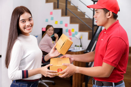 Delivery man delivering package to homeowner. Woman accepting a delivery of boxes from deliveryman....