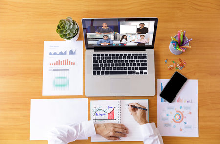 Top view Businessman and businesswoman analysis financial chart with videoconference online meeting....